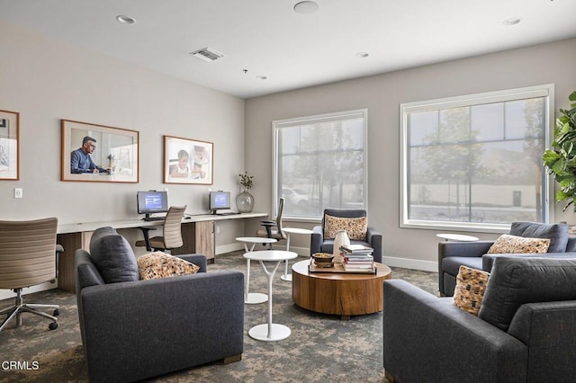 living area featuring recessed lighting, visible vents, built in desk, and baseboards