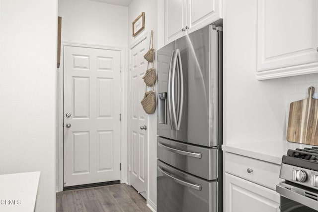 kitchen featuring stainless steel appliances, dark wood-style flooring, white cabinets, light countertops, and tasteful backsplash