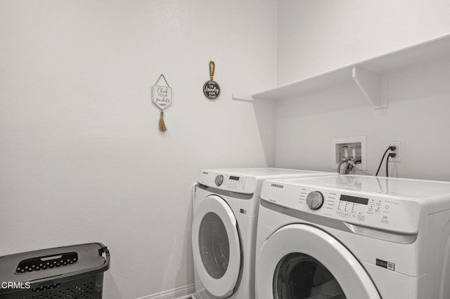 laundry area featuring washing machine and dryer, laundry area, and baseboards