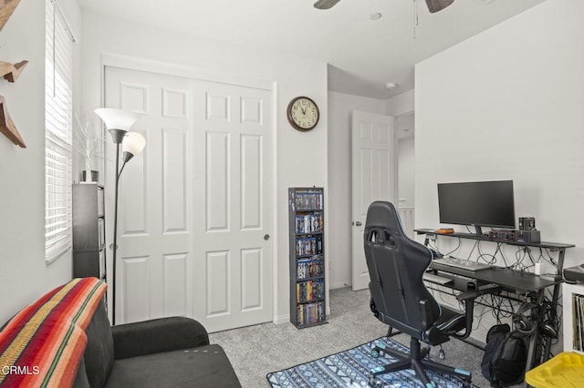 home office with a ceiling fan, carpet, and a healthy amount of sunlight