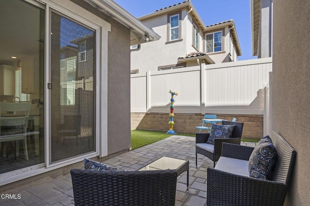 view of patio featuring an outdoor living space and fence