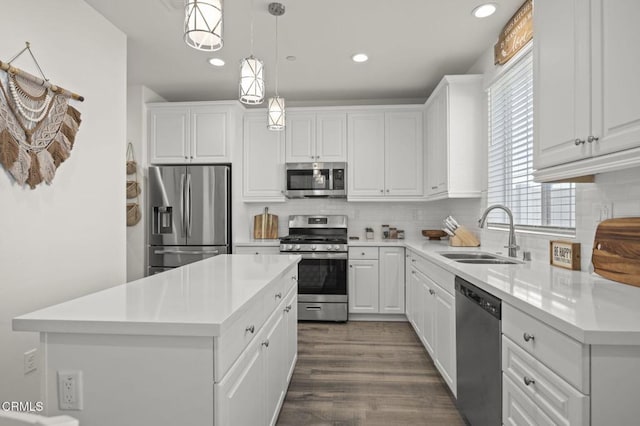 kitchen featuring recessed lighting, white cabinetry, a sink, and appliances with stainless steel finishes