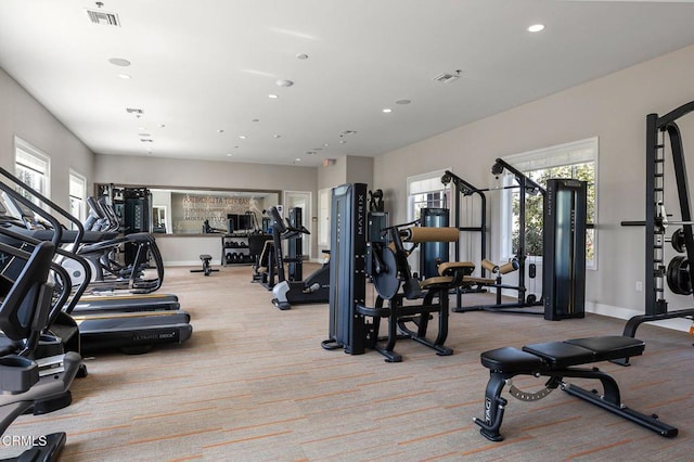 exercise room with visible vents, a wealth of natural light, recessed lighting, and carpet flooring