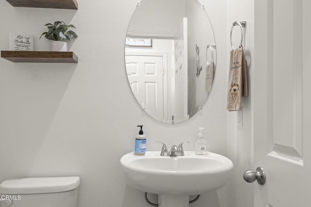 bathroom with toilet and a sink