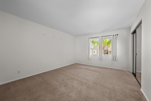 empty room featuring baseboards and carpet floors