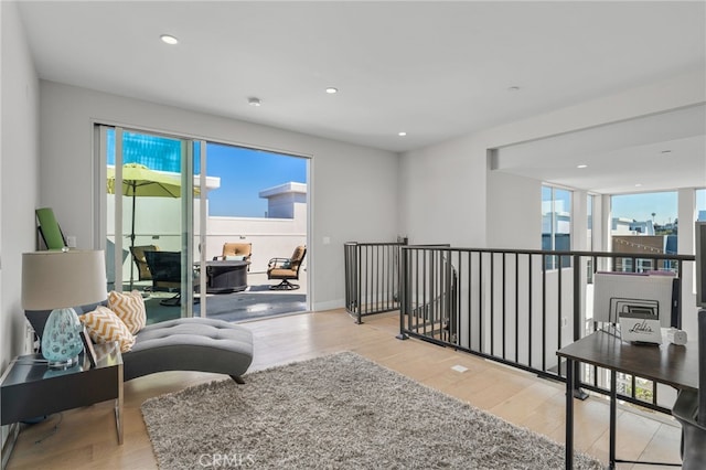 sitting room with recessed lighting, baseboards, and wood finished floors