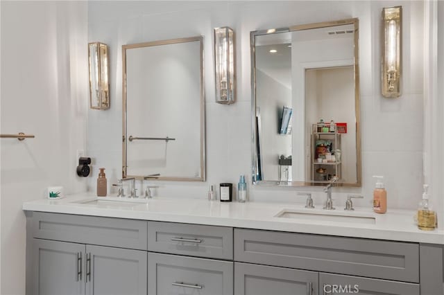 bathroom featuring a sink and double vanity