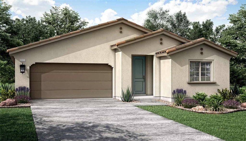 mediterranean / spanish home featuring concrete driveway, a tiled roof, an attached garage, and stucco siding