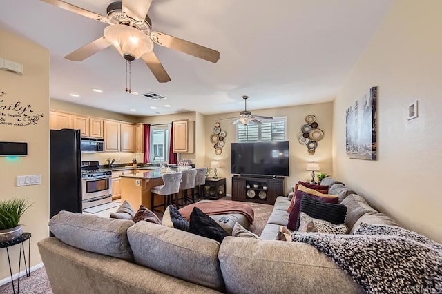 living area featuring recessed lighting, visible vents, light carpet, ceiling fan, and baseboards