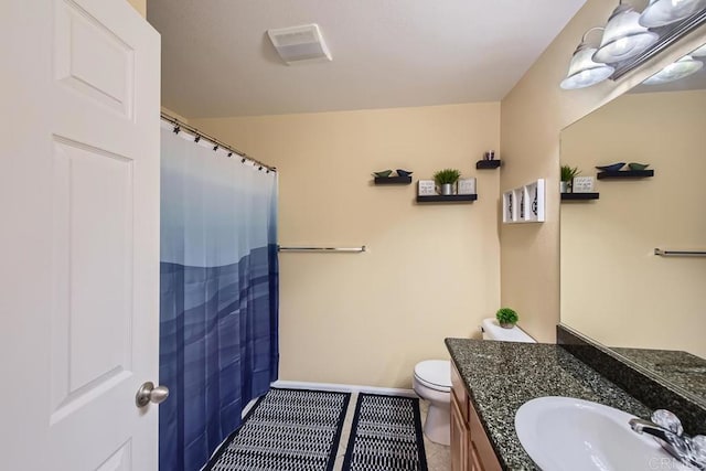 bathroom with tile patterned flooring, toilet, visible vents, vanity, and baseboards