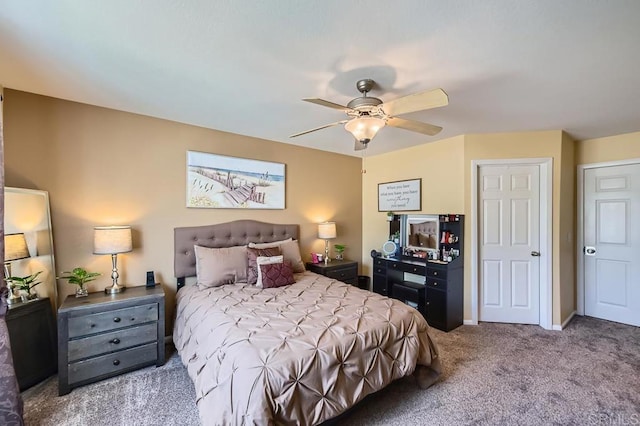 carpeted bedroom featuring ceiling fan and baseboards