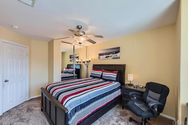 carpeted bedroom featuring ceiling fan, a closet, visible vents, and baseboards