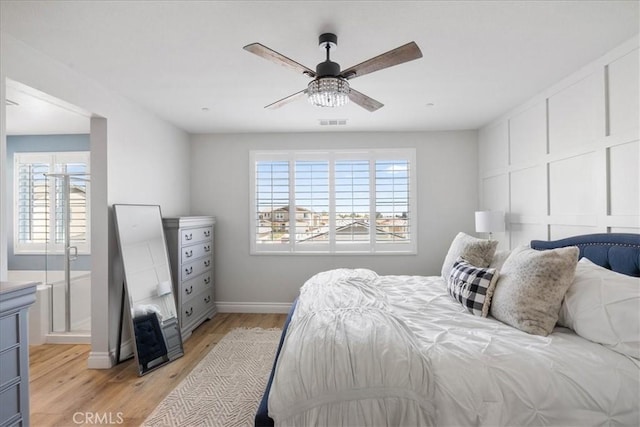 bedroom with baseboards, a ceiling fan, visible vents, and light wood-style floors