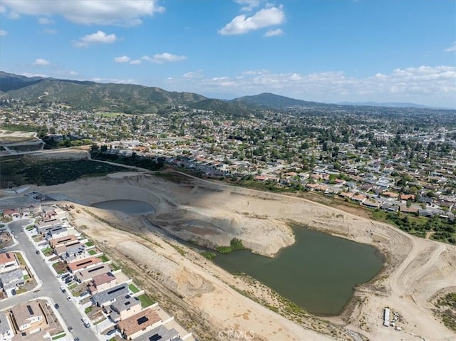 drone / aerial view with a residential view and a water and mountain view