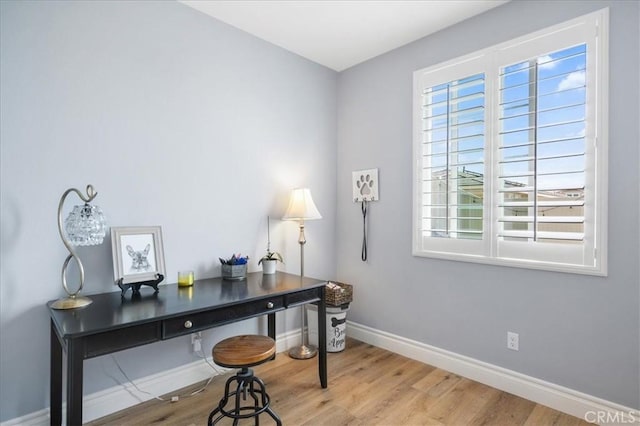 home office featuring light wood-style flooring and baseboards