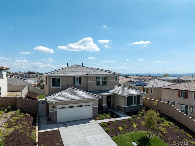 view of front facade featuring driveway, a garage, a residential view, a tiled roof, and fence