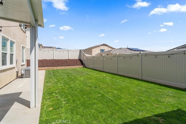 view of yard featuring a patio area, a fenced backyard, and central air condition unit