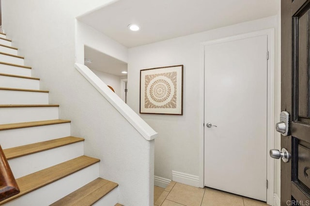 foyer entrance featuring light tile patterned floors, stairway, recessed lighting, and baseboards