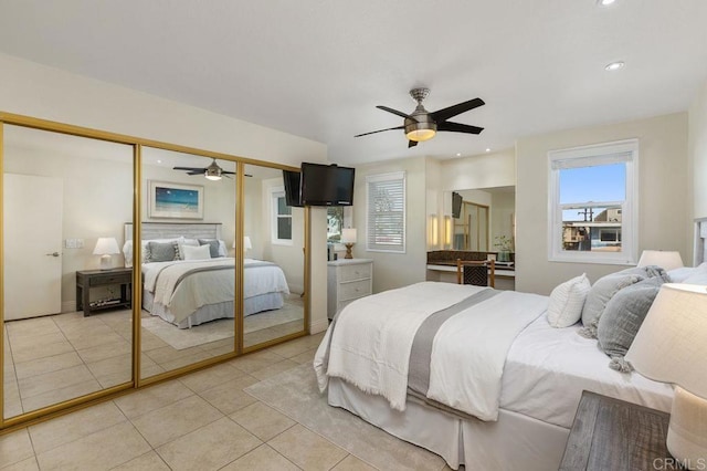 bedroom featuring multiple windows, light tile patterned flooring, a closet, and recessed lighting