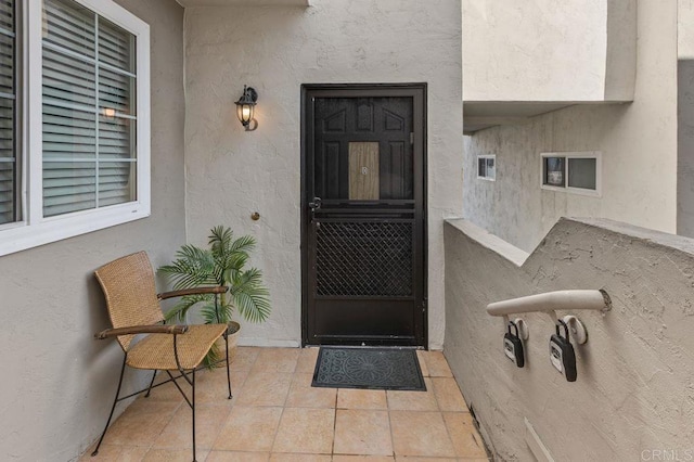 doorway to property featuring stucco siding