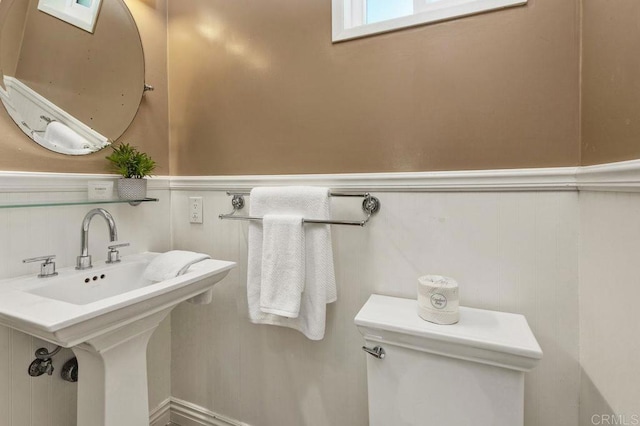 bathroom with wainscoting and toilet