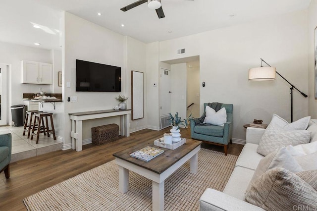 living room with baseboards, visible vents, a ceiling fan, wood finished floors, and recessed lighting