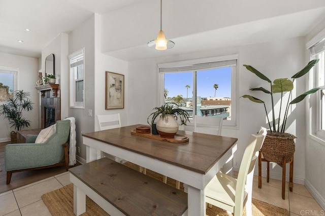 dining space featuring light tile patterned floors and baseboards