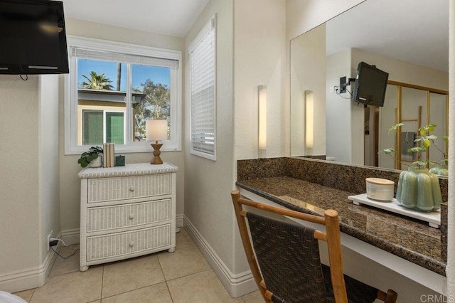 bathroom with tile patterned flooring, baseboards, and vanity