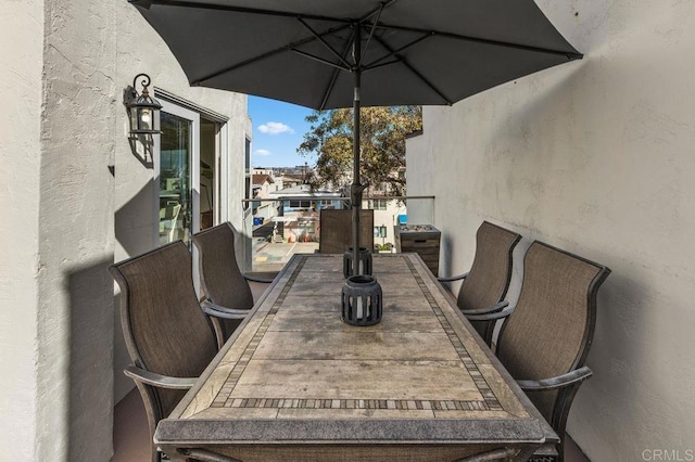 view of patio / terrace featuring a balcony and outdoor dining area