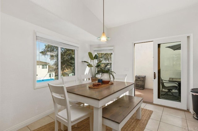 dining space with baseboards and light tile patterned floors