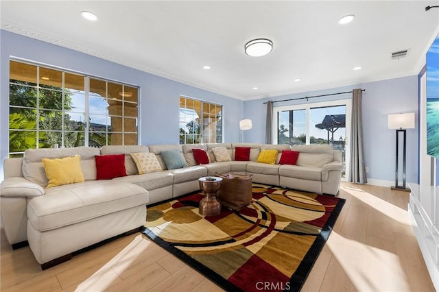 living room with recessed lighting, visible vents, ornamental molding, light wood-type flooring, and baseboards