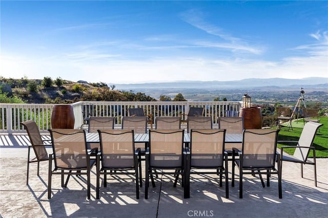 view of patio / terrace featuring outdoor dining area and a mountain view