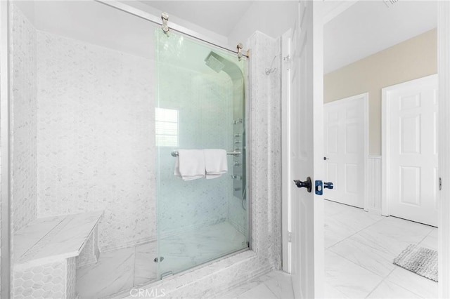 bathroom with marble finish floor and a marble finish shower