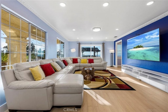 interior space with a wealth of natural light, crown molding, recessed lighting, and wood finished floors