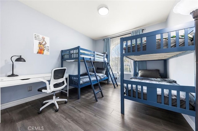 bedroom with wood finished floors and baseboards