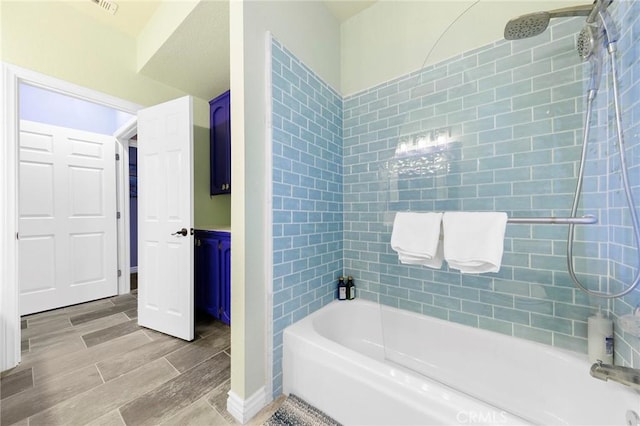 bathroom with shower / washtub combination and wood finish floors