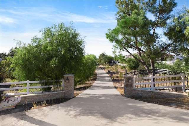 view of gate with a fenced front yard