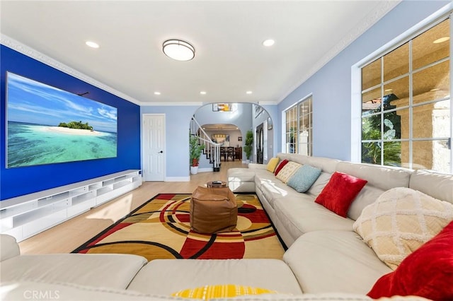 living room with arched walkways, recessed lighting, stairway, ornamental molding, and wood finished floors