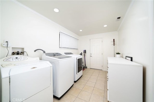 laundry room featuring light tile patterned floors, visible vents, washing machine and clothes dryer, laundry area, and ornamental molding