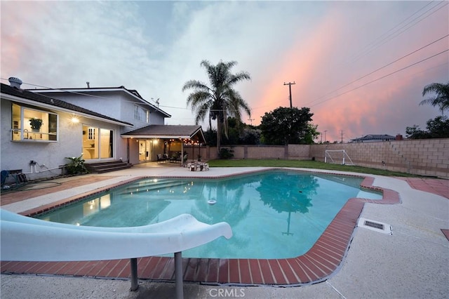 view of swimming pool featuring entry steps, a patio, a fenced backyard, and a fenced in pool