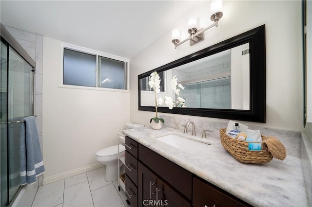 bathroom with toilet, marble finish floor, a tile shower, baseboards, and vanity