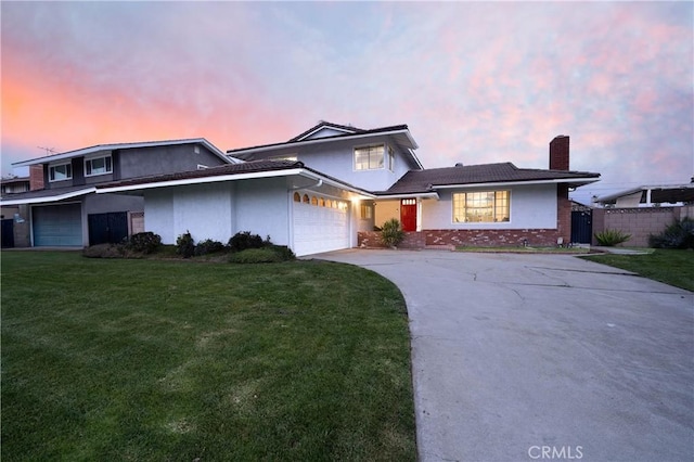 view of front of house featuring stucco siding, driveway, fence, a yard, and an attached garage