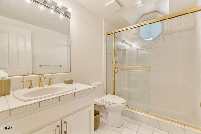 bathroom featuring a stall shower, vanity, toilet, and tile patterned floors