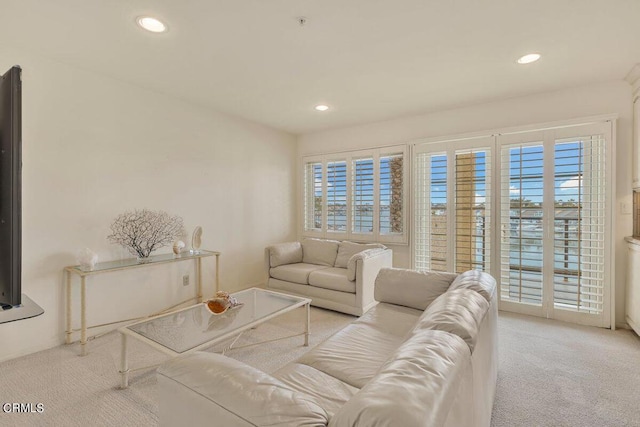 carpeted living area featuring a wealth of natural light and recessed lighting