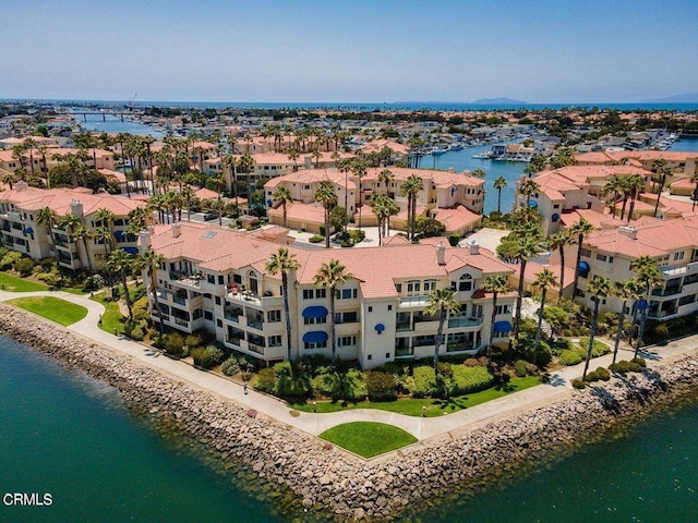 drone / aerial view featuring a residential view and a water view