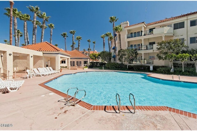 community pool with a patio