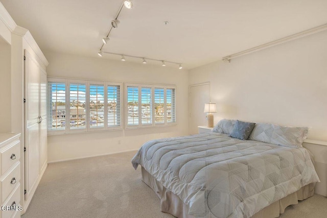 carpeted bedroom with baseboards