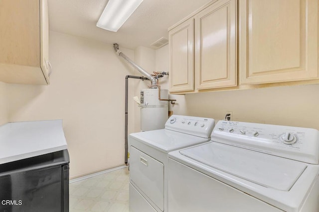 clothes washing area featuring cabinet space, visible vents, washer and clothes dryer, secured water heater, and light floors