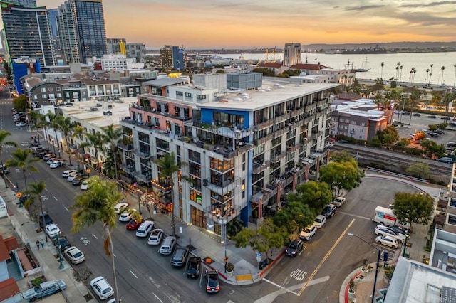 birds eye view of property featuring a view of city and a water view