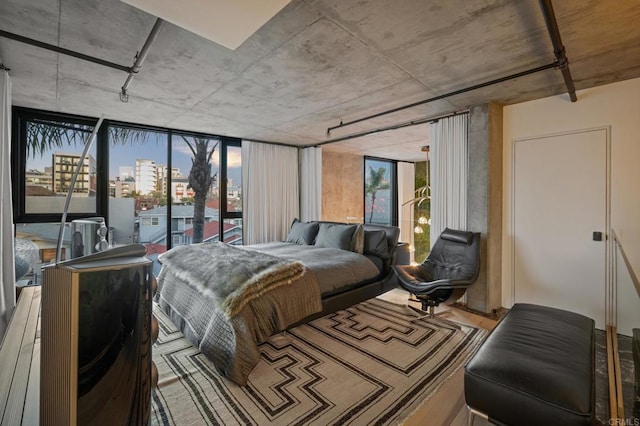 bedroom featuring multiple windows and a city view